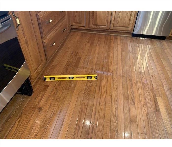 Wood flooring with a level on the boards