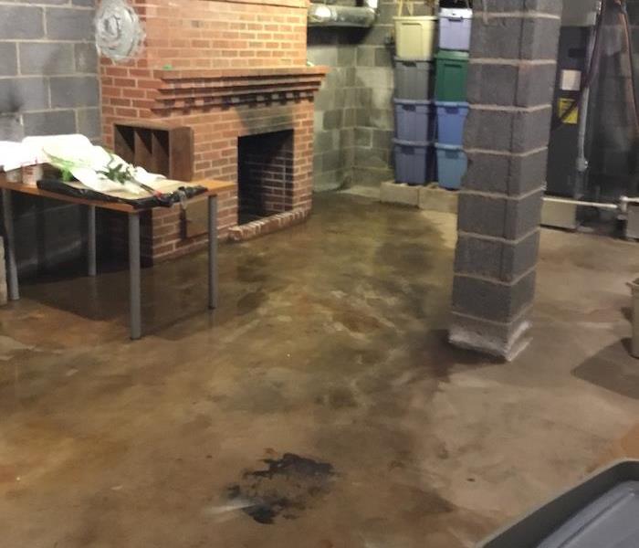basement with wet concrete floor 