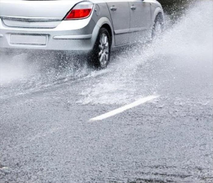 Car driving through Flooded Waters